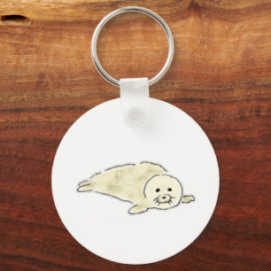 Llavero Cachorro de foca arpa blanca esponjosa acostado