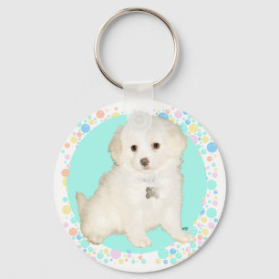 Llavero cachorro mestizo de caniche / bichón celebra la vi