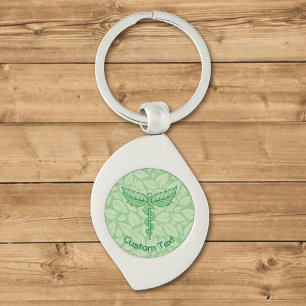 Llavero Caduceus con la cadena de claves de fondo de hojas