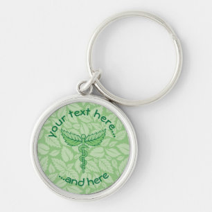Llavero Caduceus con la cadena de claves de fondo de hojas