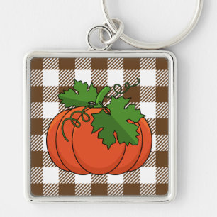 Llavero Calabaza naranja sobre el patrón de cuadros de col