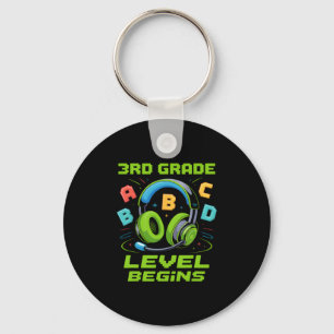 Llavero Camiseta Comienza El Primer Día De Tercer Grado Ni