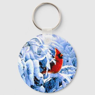 Llavero Cardenal rojo en la nieve de invierno