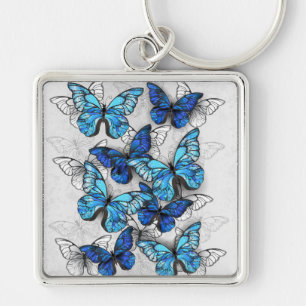 Llavero Composición de las mariposas blancas y azules