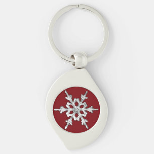 Llavero Copo de nieve plateado y blanco sobre rojo profund