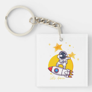 Llavero danza astronauta sobre un cohete