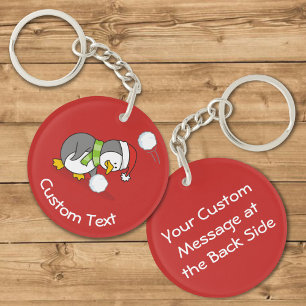 Llavero de Pingüino de Navidad recogiendo una Bola