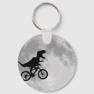 Llavero Dinosaurio en bicicleta en cielo con luna