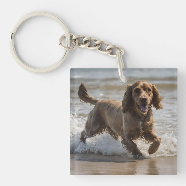 Llavero "Diversión costera: Cocker Spaniel juega en el océ (Frente)