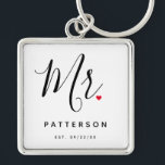 Llavero Elegante Sr. Personalizado Apellido y Boda de fech<br><div class="desc">El regalo perfecto para que cualquier novio sea, el diseño divertido y moderno cuenta con un elegante guión de tipografía "Mr." con un lindo corazón de amor rojo para todos. El diseño es fácil de personalizar con su apellido y fecha establecida y será el perfecto recuerdo de su día especial....</div>