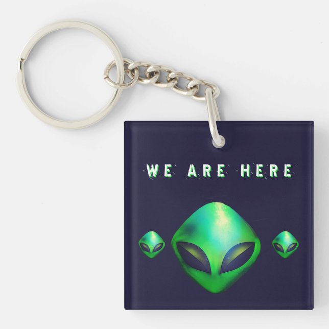 Llavero "Estamos Aquí" cabeza de alienígena verde (Frente)