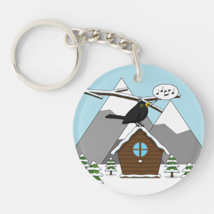 Llavero Feliz Canto de Blackbird en el paisaje invernal