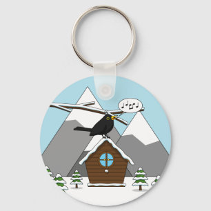 Llavero Feliz Canto de Blackbird en el paisaje invernal