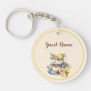 Llavero Fiesta de té en taza de limón con nombre de invita