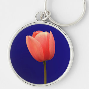 Llavero flor de tulipán naranja sobre fondo azul