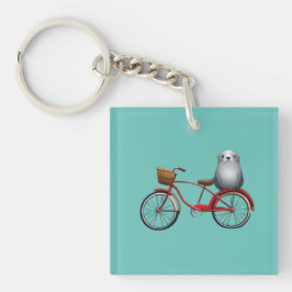 Llavero Foca de dibujos animados linda en una bicicleta
