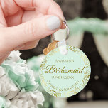 Llavero Fragmentos de oro en regalo de Boda de la dama de<br><div class="desc">Estas cadenas están diseñadas para dar como favores a las damas de honor en tu fiesta de bodas. Presentan un diseño sencillo y elegante con un fondo de color verde menta pálido, letras de guión dorado y un florido Relieve metalizado de imitación dorada y encalado. El texto dice "niñera de...</div>
