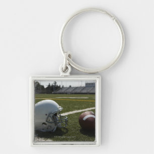 Llavero Fútbol y casco de fútbol americano en campo de