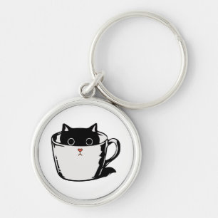 Llavero Gatito negro con nariz roja escondido en una taza