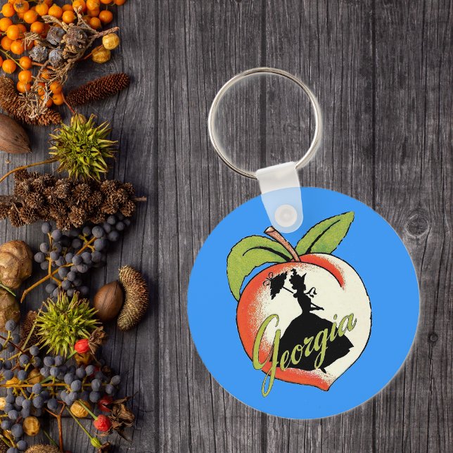 Llavero Georgia Peach Keychain (Southern bell lady silhouette on peach with Text Georgia on vibrant blue keychain.)