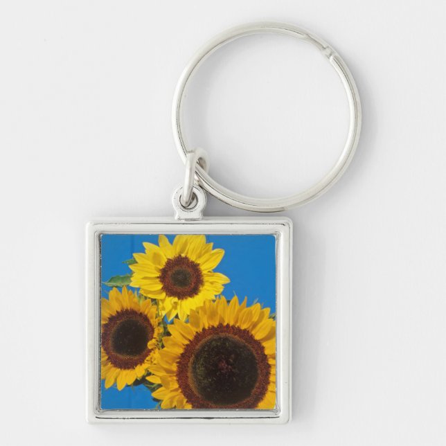 Llavero Girasoles contra cerca azul (Frente)
