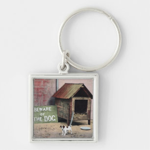 Llavero Guárdese de muestra del perro con el pequeño per