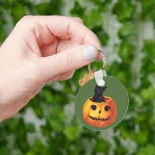 Llavero Halloween vintage, gato negro lindo en una calabaz