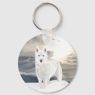 Llavero Husky blanco con ojos azules, en la nieve