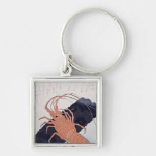 Llavero Langoustine con un bloque del carbón de leña,