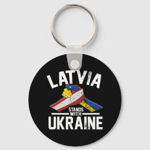 Llavero Letonia está de pie con la bandera ucraniana leton