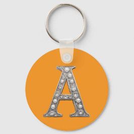 Llavero Letra A con joyas sobre fondo amarillo