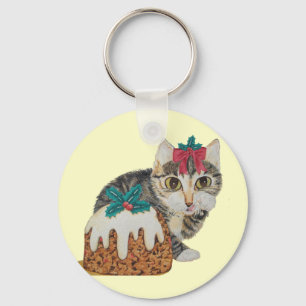 Llavero lindo gatito grisáceo lamiendo navidades de pata