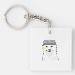 Llavero Lindo perro blanco con sombrero sosteniendo flor a