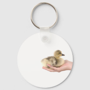 Llavero little goose in one hand