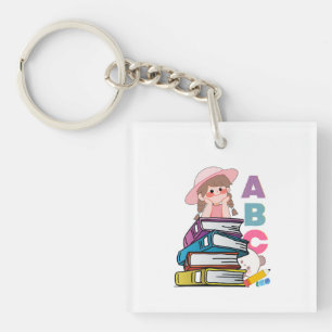 Llavero Llaverito de niña linda leyendo libros y alfabeto