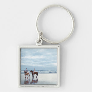 Llavero Los caballos de un montar a caballo de los pares