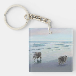 Llavero Manos en la pintura de perro en la costa