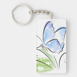 Llavero Mariposa que se sienta en hierba sobre campo de