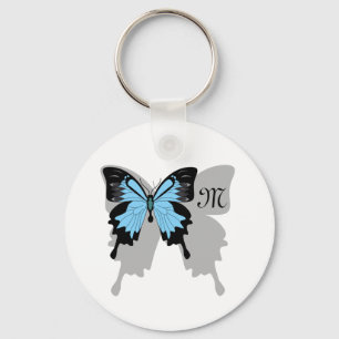 Llavero Monograma de sombra de mariposa azul con respaldo