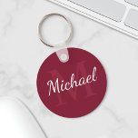 Llavero Monograma personalizado y nombre rojo borgoña<br><div class="desc">El Monograma y el Regalo de nombres personalizados presentan un nombre personalizado en el estilo de fuente de escritura blanca y un monograma en el estilo de fuente de serif rojo burdeos claro como fondo, sobre fondo rojo borgoña. Perfecto como regalo de vacaciones, favores de reunión familiar, gracias a los...</div>