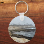 Llavero Morro Bay California Coastal Photography<br><div class="desc">A foggy overcast day in Morro Bay California with the ocean waves hitting the rocks on the shore in this beach photograph souvenir. This seaside travel photo keepsake keychain features black cursive script above the beach rocks and grey sky.</div>