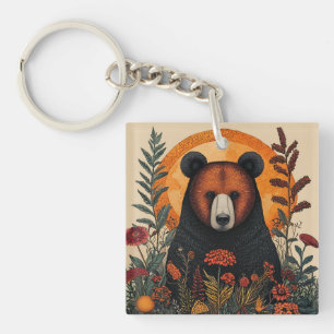 Llavero Oso artístico entre flores botánicas vibrantes