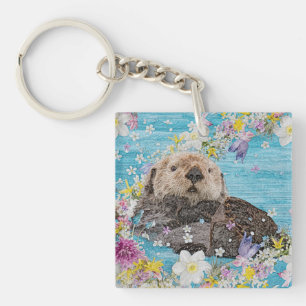 Llavero Otter de cuento de hadas en río de flores