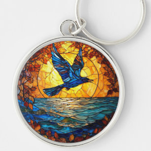 Llavero Pájaro volador sobre el océano al atardecer
