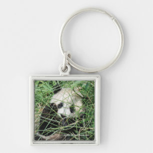 Llavero Panda gigante que oculta en hierba