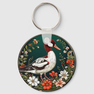 Llavero Pato elegante rodeado de flores vibrantes