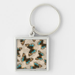 Llavero Patrón de mariposa azul Pansy en blanco roto