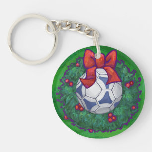 Llavero Pelota de fútbol blanca y azul en verde