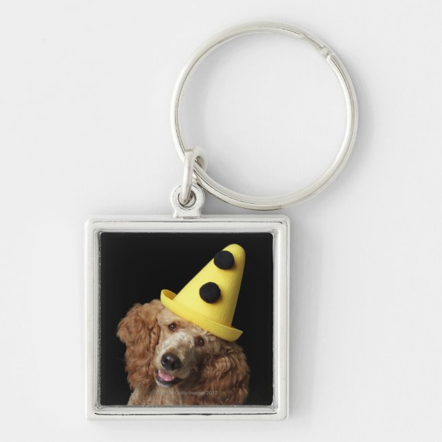 Llavero Perro de caniche de oro que lleva un gorra (Frente)
