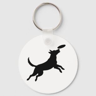 Llavero perro saltando para atrapar un frisbee
